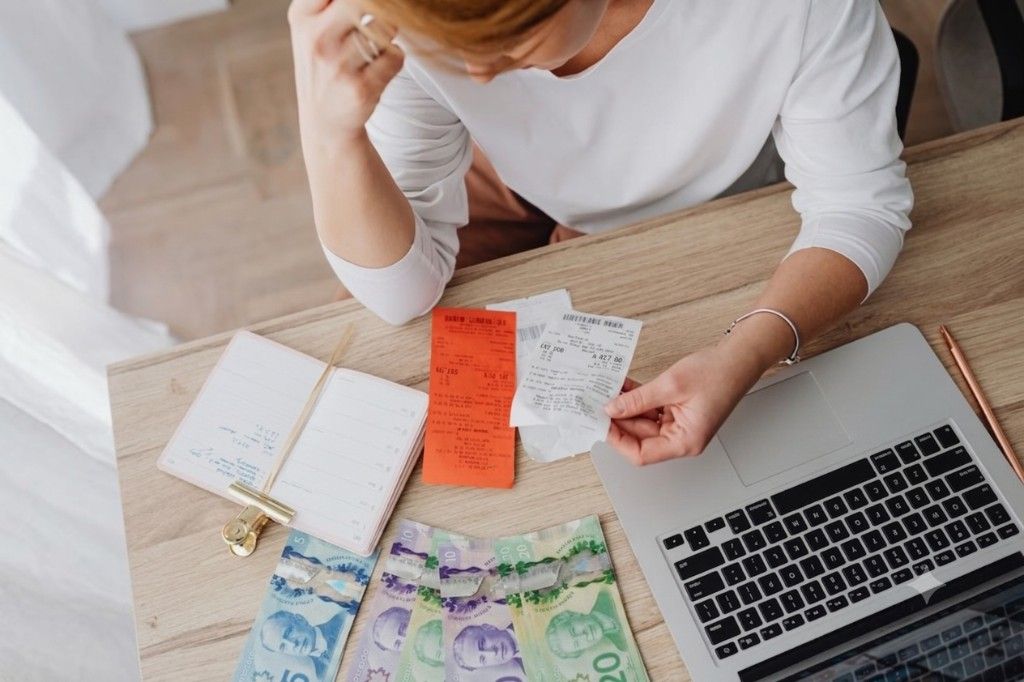 Person reviewing everyday expenses and receipts at home